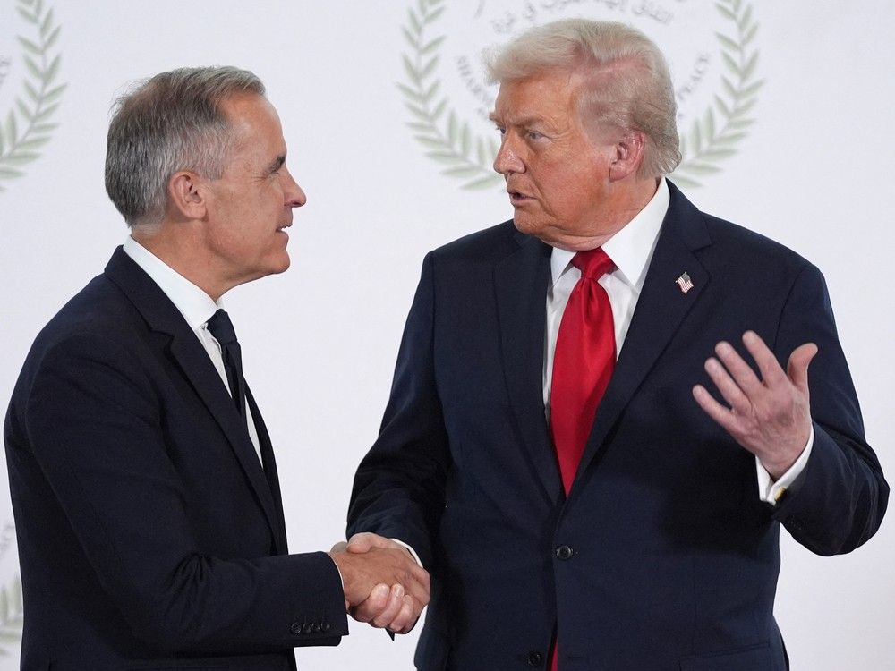U.S. President Donald Trump greets Canada's Prime Minister Mark Carney during a summit on Gaza in Sharm el-Sheikh on October 13, 2025.