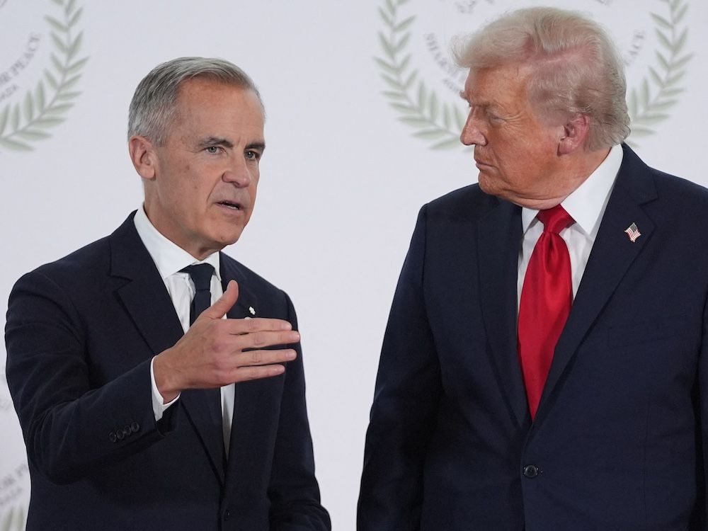  US President Donald Trump greets Canada’s Prime Minister Mark Carney during a summit on Gaza in Sharm el-Sheikh on October 13, 2025.