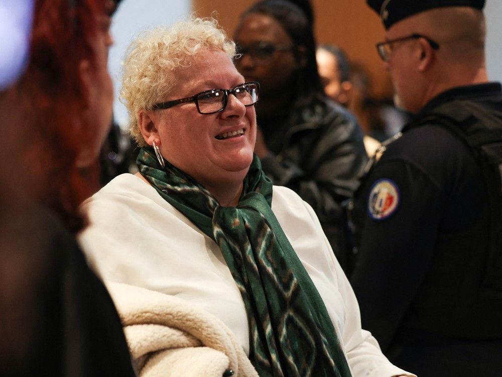  Delphine J also known as Amandine Roy speaks to the press as she arrives for her trial with nine other persons accused of sexist cyber-harassment of Brigitte Macron, in Paris, on Oct. 27, 2025.