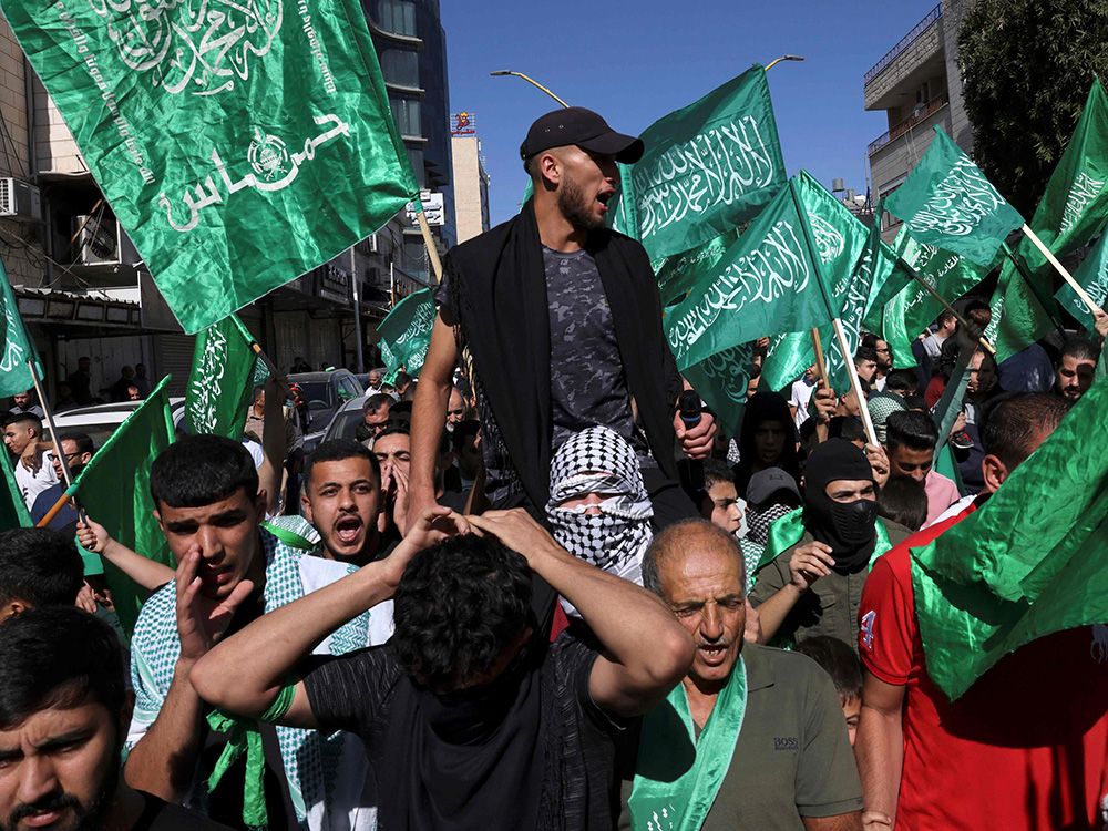 Palestinians in the West Bank hold Hamas flags. Hamas are genocidal terrorists, Richard Kemp says, “by the definition of their charter, which requires them to kill not just the Jews in Israel but Jews everywhere.” Palestinians in the West Bank hold Hamas flags. Hamas are genocidal terrorists, Richard Kemp says, “by the definition of their charter, which requires them to kill not just the Jews in Israel but Jews everywhere.”