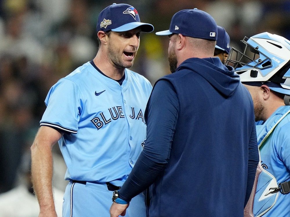 Toronto Blue Jays pitcher Max Scherzer (31) shares some words with Toronto Blue Jays manager John Schneider during a visit to the mound in fifth inning MLB American League Championship Series game 4 baseball action against the Seattle Mariners, in Seattle, Thursday, Oct. 16, 2025.