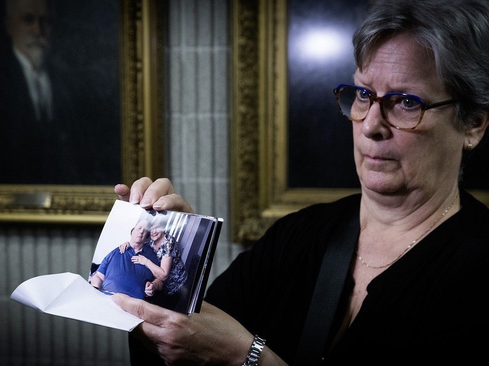 Sylvie Brosseau, the widow of Normand Meunier, holds one of the last pictures of themselves together to members of the media on May 15, 2025. She testified that day at a coroner's inquest into Meunier, a quadriplegic patient who developed excruciating bedsores, leading him to seek medical assistance in dying.