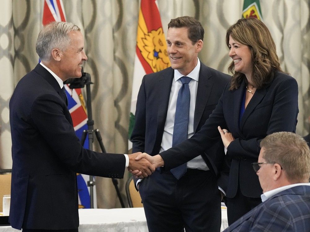 Prime Minister Mark Carney, left, greets Alberta Premier Danielle Smith, right, during the 2025 summer meetings of Canada's Premiers at Deerhurst Resort in Huntsville, Ont., on Tuesday, July 22, 2025. Prime Minister Mark Carney, left, greets Alberta Premier Danielle Smith, right, during the 2025 summer meetings of Canada's Premiers at Deerhurst Resort in Huntsville, Ont., on Tuesday, July 22, 2025.