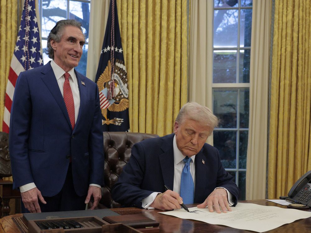 U.S. President Donald Trump signs Interior Secretary Doug Burghum's commission in the Oval Office on Jan. 31, 2025.