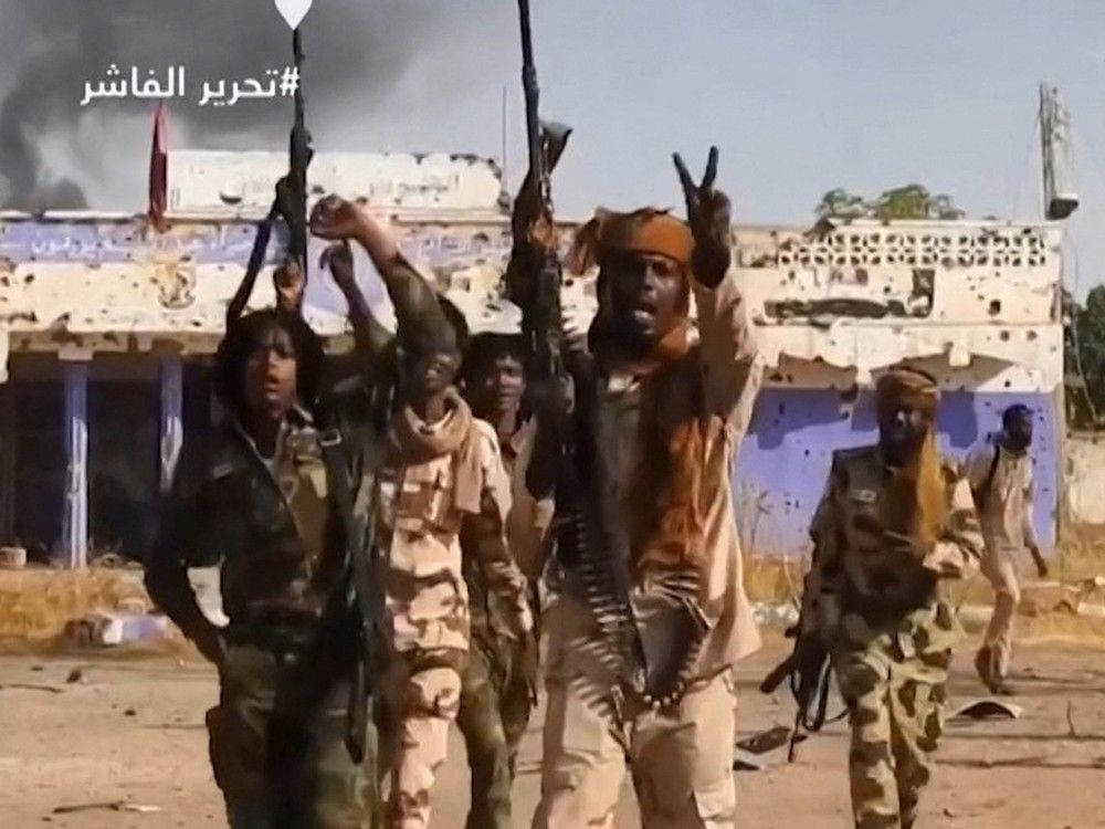  This image grab taken from handout video footage released on Sudan’s paramilitary Rapid Support Forces (RSF) Telegram account on October 26, 2025, shows RSF fighters holding weapons and celebrating in the streets of El-Fasher in Sudan’s Darfur.
