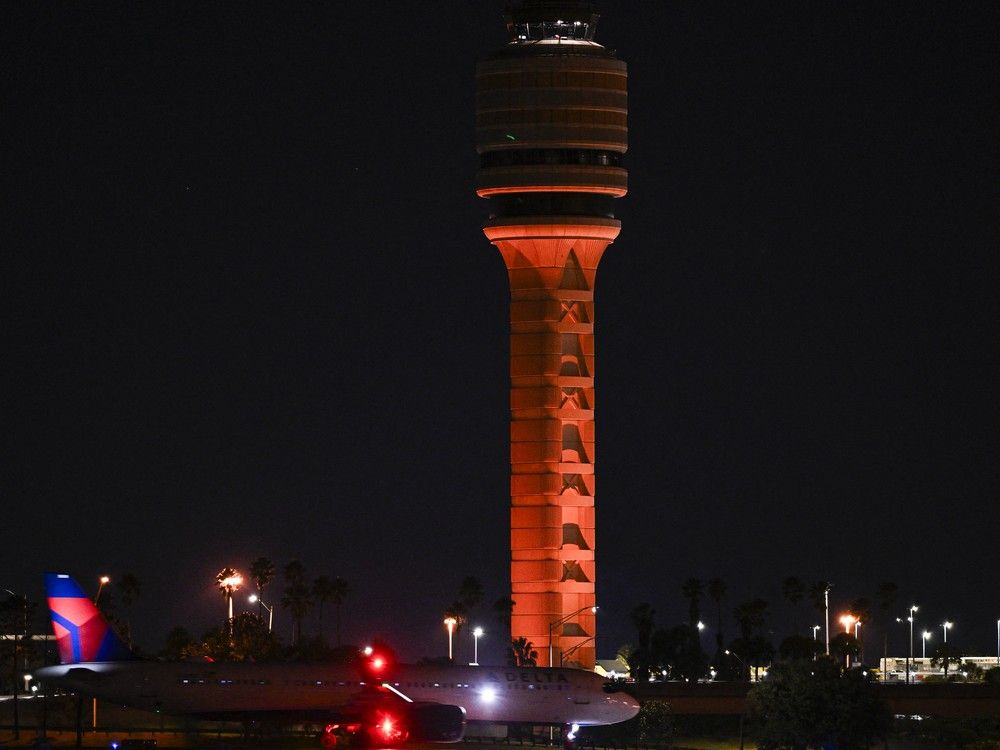  FILE: The air traffic control tower is seen at Orlando International Airport in Orlando, Florida early morning on October 31, 2025.