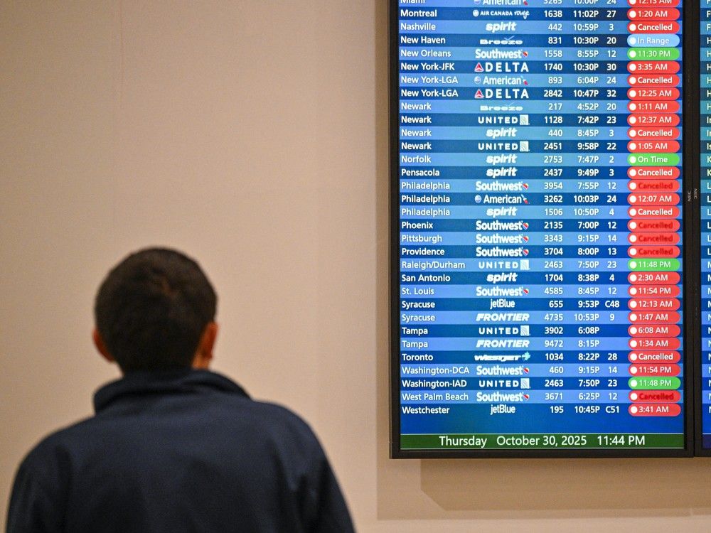  FILE: Cancelled flights are seen on a screen at Orlando International Airport in Orlando, Florida on October 30, 2025.