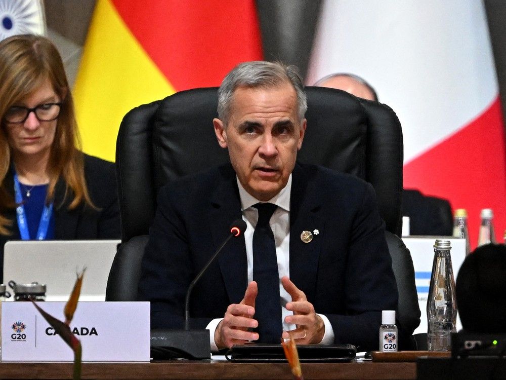 Canadian Prime Minister Mark Carney delivers a speech during a G20 Leaders' Summit plenary session at the Nasrec Expo Centre in Johannesburg on November 22, 2025.