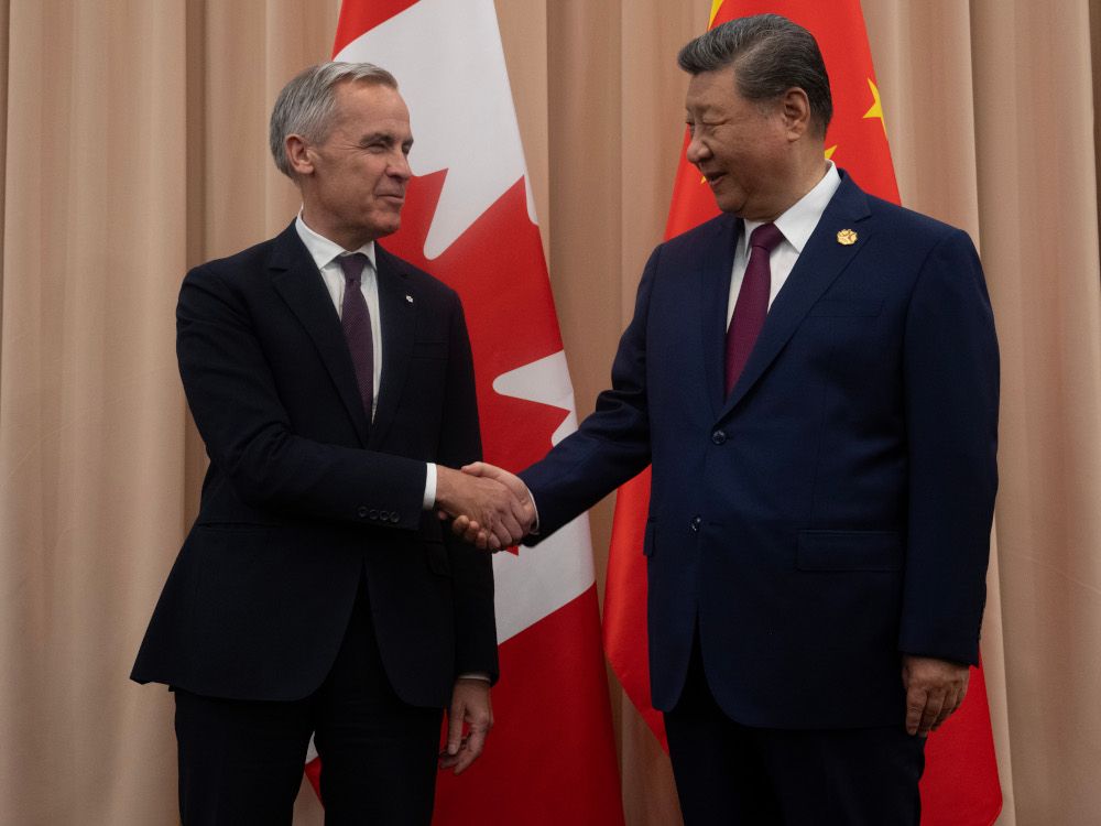 Prime Minister Mark Carney, left, shakes hands with Chinese President Xi Jinping at the start of a meeting in Gyeongju, South Korea, on Oct. 31.