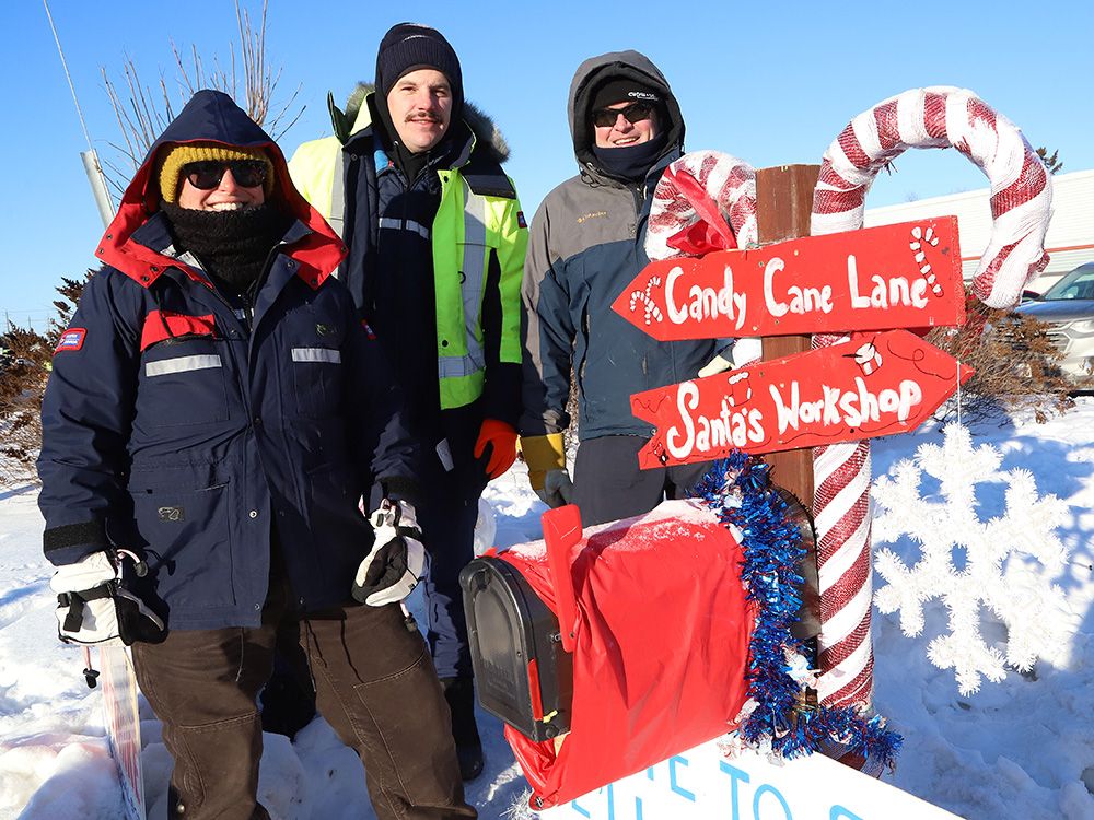 Striking Canada Post workers stand near a mailbox set up by strikers to accept Santa letters in Sudbury, Ont., Dec. 13, 2024. As of November 2025, Canada Post workers are still without a contract and holding rotating strikes, while the Crown corporation is losing millions of dollars a day.