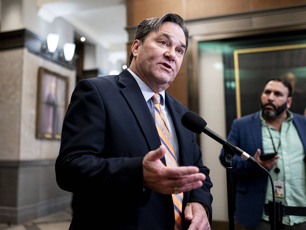 NDP Interim Leader Don Davies speaks to reporters in the foyer of the House of Commons on Wednesday, Oct. 8, 2025.