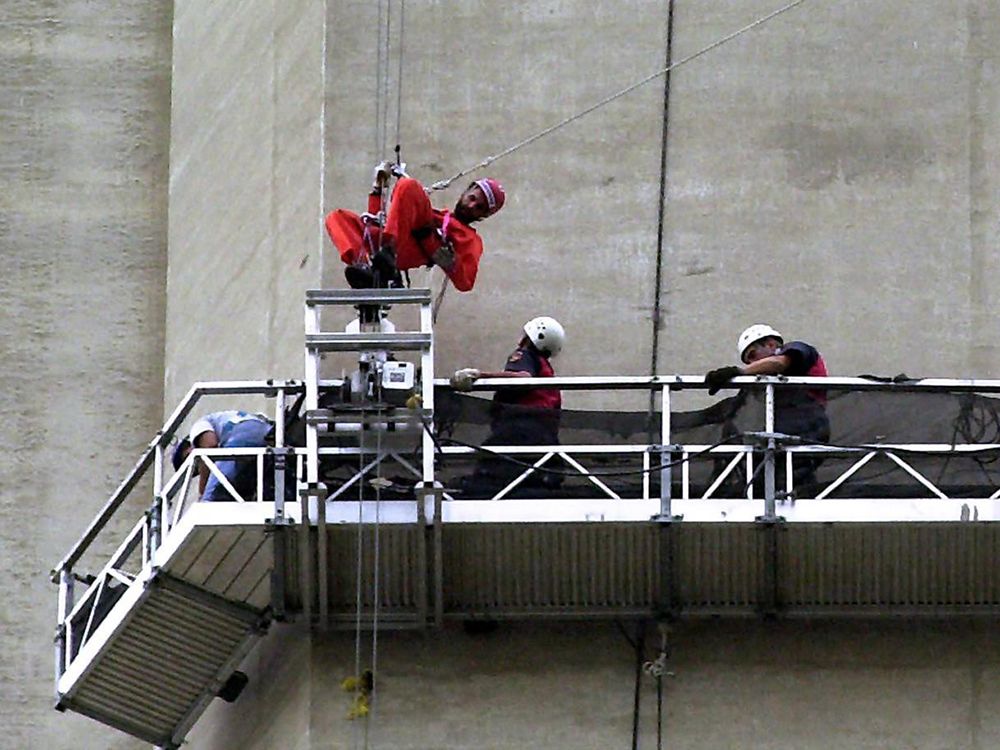  Greenpeace activist Steven Guilbeault, 31, is met by police on the side of the CN Tower in Toronto, July 16, 2001.