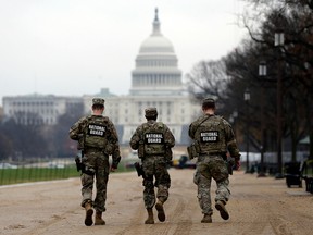 Three National Guards and U.S. Capitol.