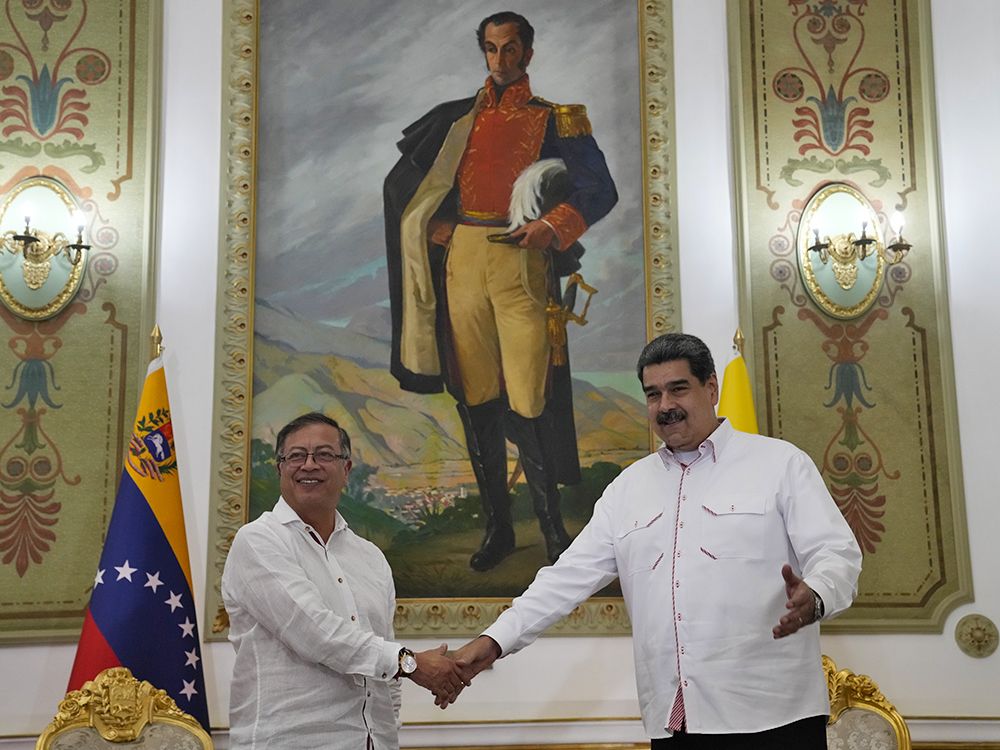 Colombia's President Gustavo Petro, left, and Venezuelan President Nicolas Maduro shake hands, backdropped by a painting of independence hero Simon Bolivar, before a private meeting at the Miraflores Presidential Palace in Caracas, Venezuela, Nov. 1, 2022. Colombia's President Gustavo Petro, left, and Venezuelan President Nicolas Maduro shake hands, backdropped by a painting of independence hero Simon Bolivar, before a private meeting at the Miraflores Presidential Palace in Caracas, Venezuela, Nov. 1, 2022.