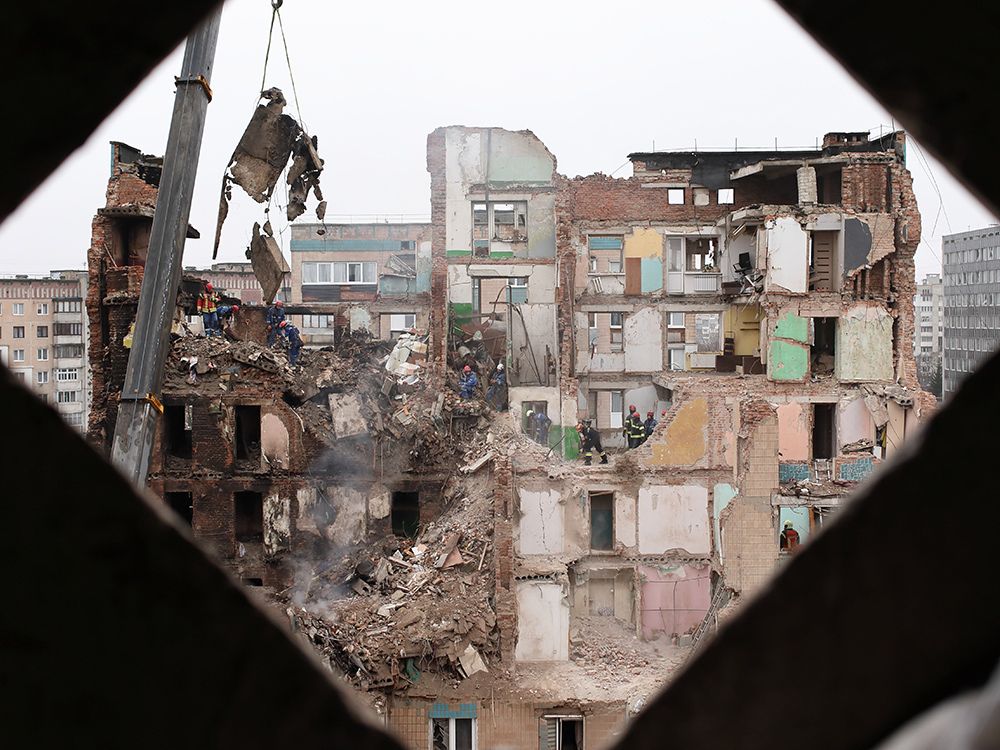 Rescue workers clear the rubble of a residential building which was heavily damaged by a Russian strike on Ternopil, Ukraine, Friday, Nov. 21, 2025.