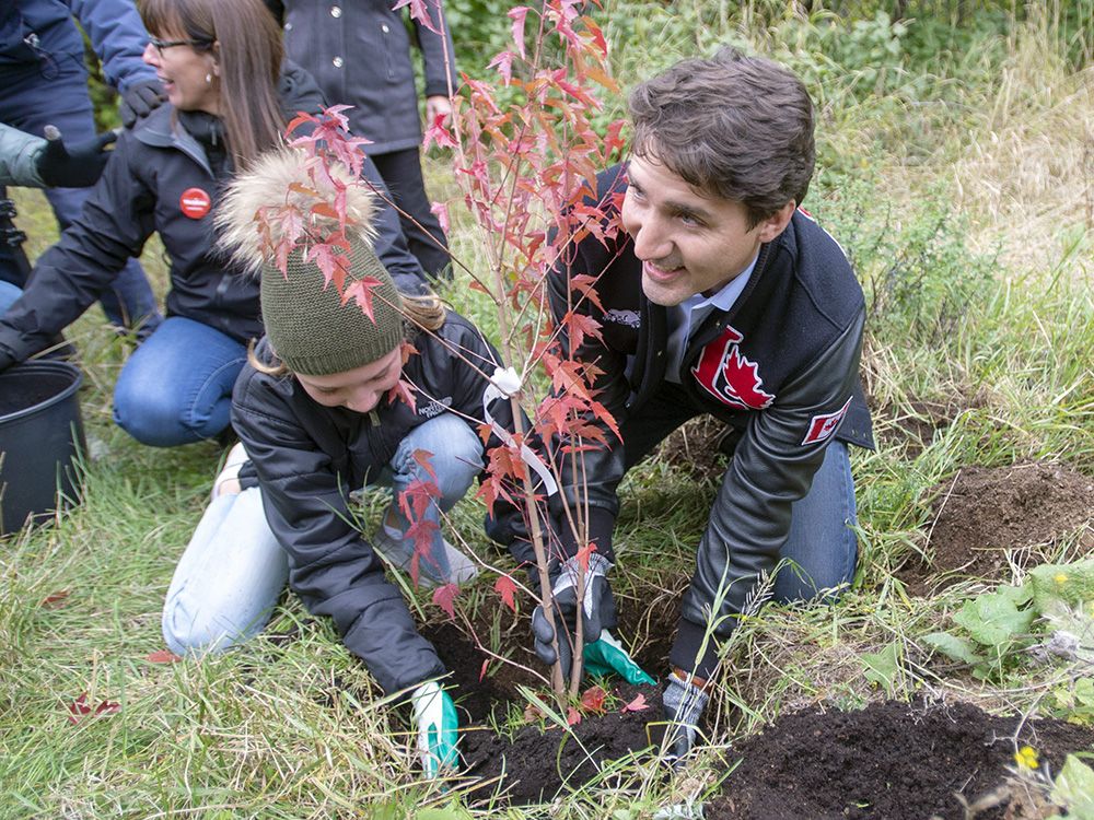 Then Liberal leader Justin Trudeau and his daughter, Ella-Grace, plant a tree during the 2019 federal election campaign, in Saint-Anaclet, Que., on October 4, 2019.
