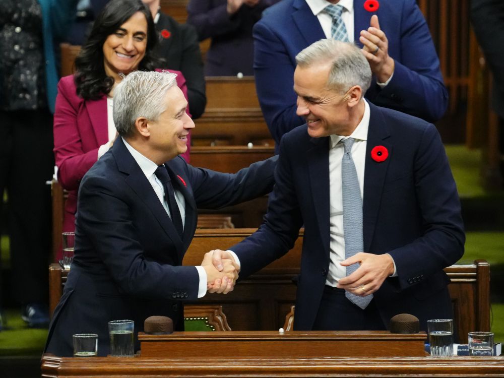  Finance Minister Francois-Philippe Champagne, left, shakes hands with Prime Minister Mark Carney after delivering the federal budget in the House of Commons in Ottawa on Tuesday.