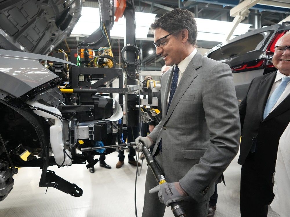  Prime Minister Justin Trudeau holds a tool along an assembly line at an event announcing plans for a Honda electric vehicle battery plant in Alliston, Ont. on Thursday, April 25, 2024.