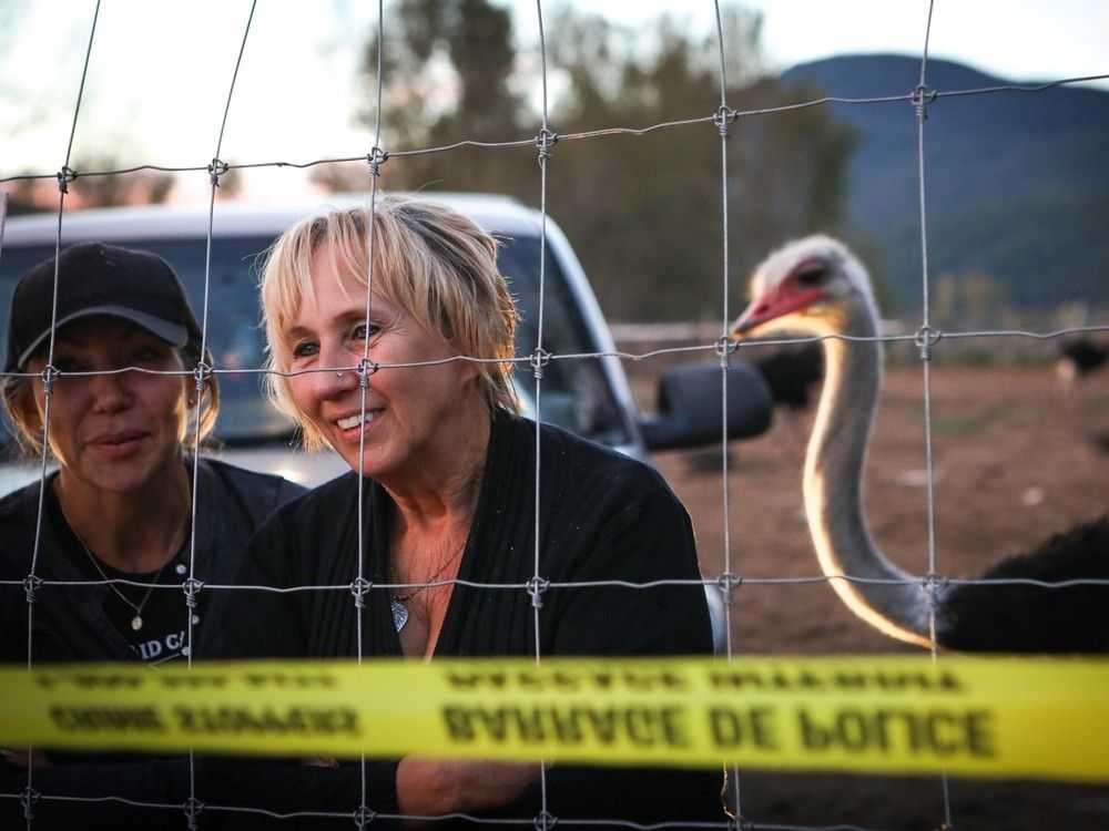 Karen Espersen, centre, the co-owner of Universal Ostrich Farms, speaks with supporters with her daughter, Katie Pasitney, at the farm in Edgewood, B.C., on Monday, Sept. 22, 2025.