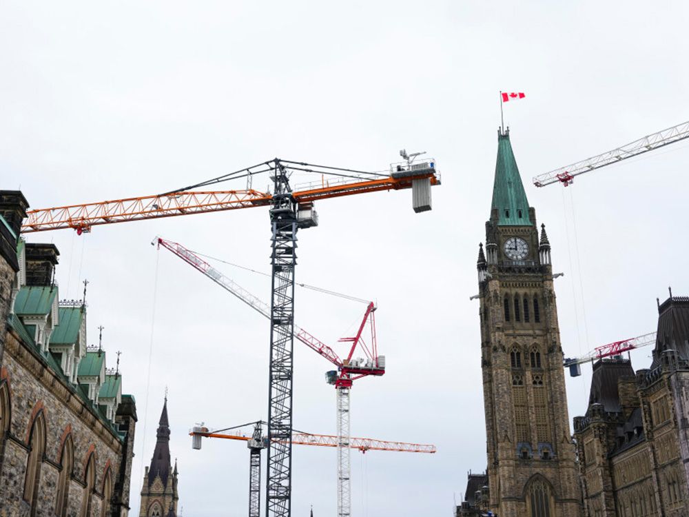  Construction cranes operate on Parliament Hill in Ottawa. Prime Minister Mark Carney tabled his first federal budget on Nov. 4.