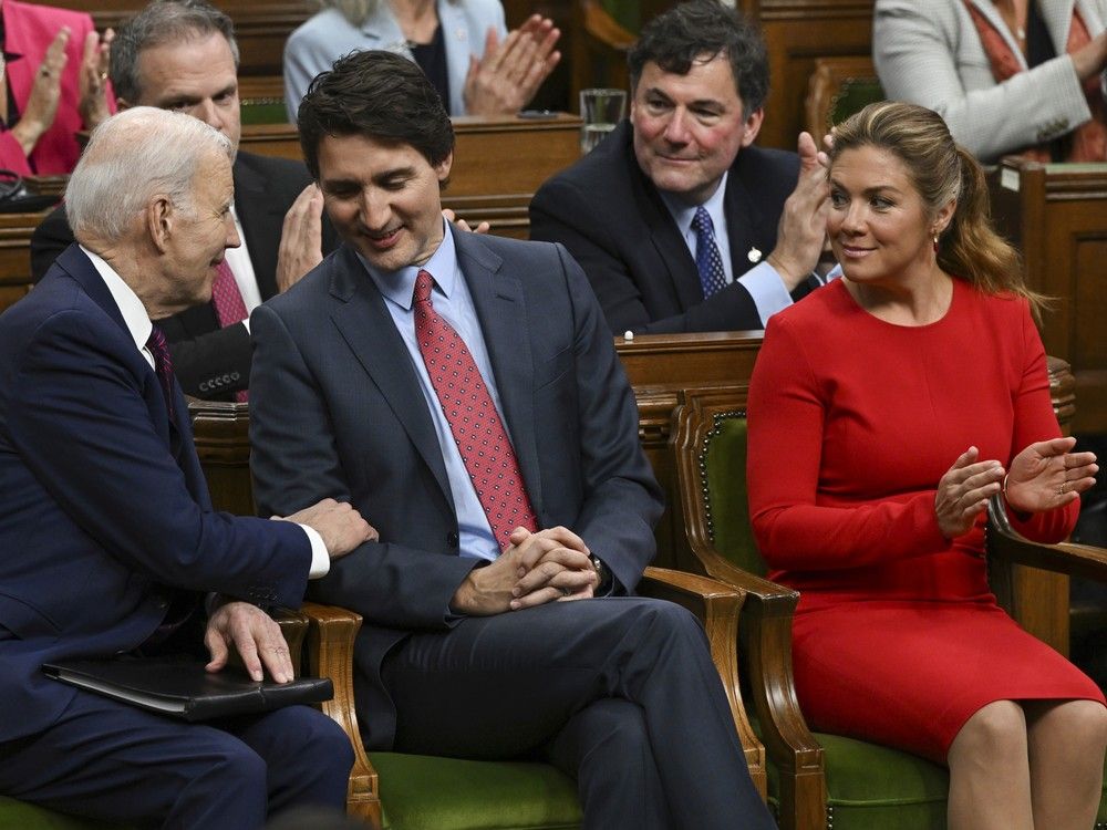 Former President Joe Biden speaking with former Prime Minister Justin Trudeau in the House of Commons in March 2023, with Sophie Gregoire Trudeau looking on. Former President Joe Biden speaking with former Prime Minister Justin Trudeau in the House of Commons in March 2023, with Sophie Gregoire Trudeau looking on.