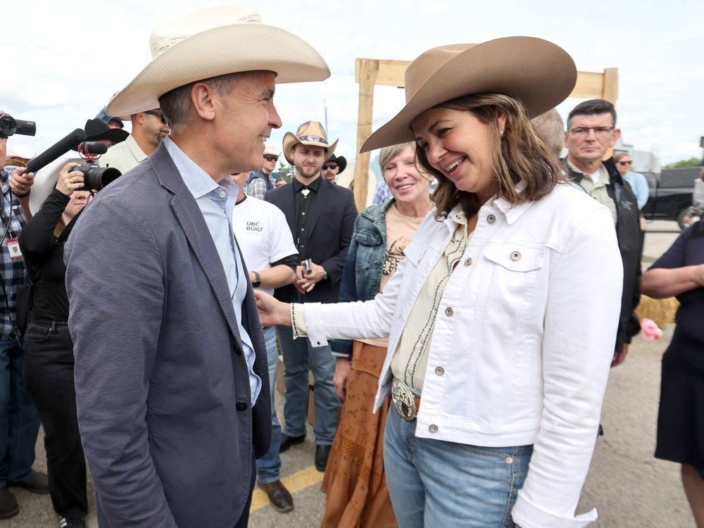 Prime Minister Mark Carney meets with Alberta Premier Danielle Smith during a Stampede breakfast at the United Brotherhood of Carpenters and Joiners of America in Calgary on Friday, July 4, 2025.