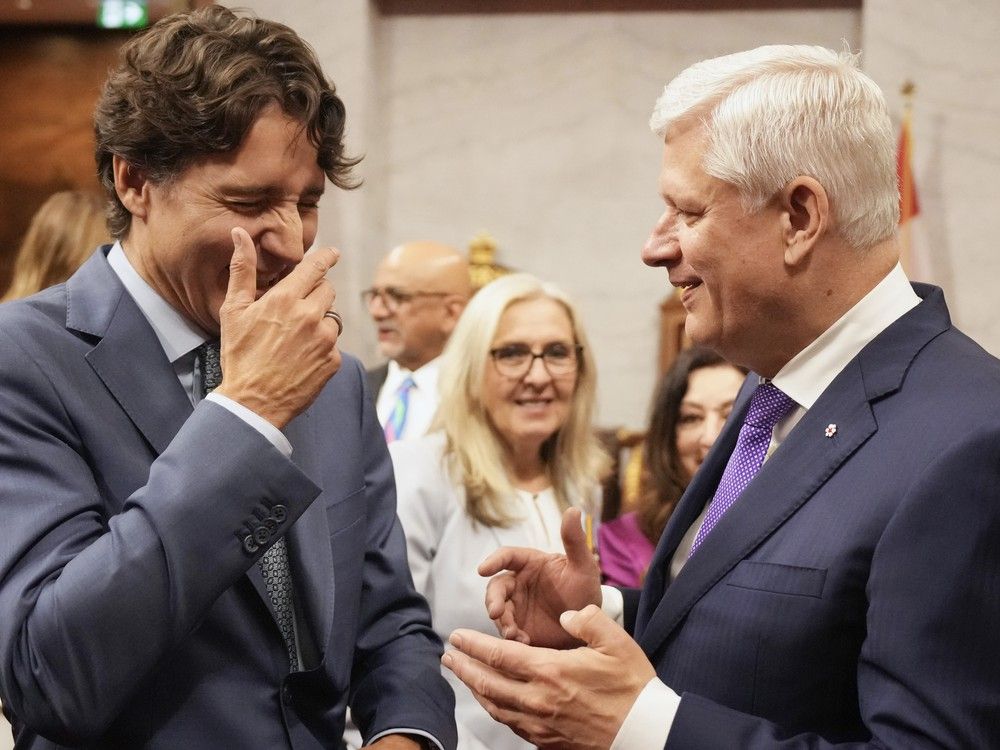  Former prime ministers Justin Trudeau, left, and Stephen Harper share a laugh ahead of King Charles delivering the speech from the throne in the Senate in Ottawa on Tuesday, May 27, 2025.