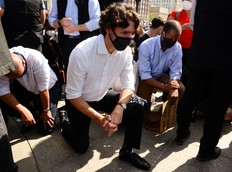 Prime Minister Justin Trudeau takes a knee during an 8 minute and 46 second silence as he takes part in an anti-racism protest on Parliament Hill during the COVID-19 pandemic in Ottawa on Friday, June 5, 2020.