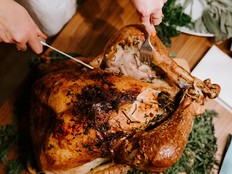 A person carves a roast turkey