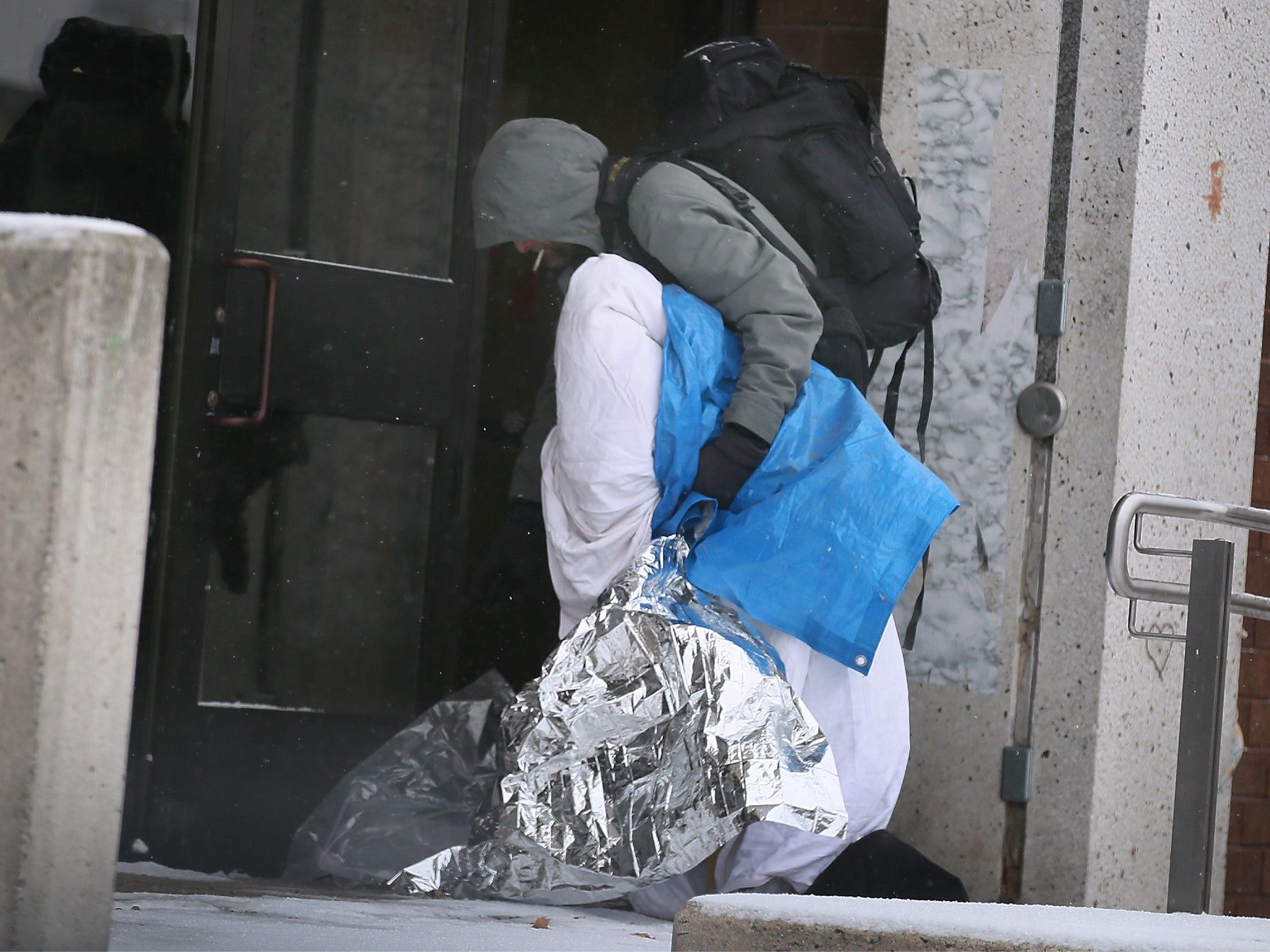 A homeless man in Windsor colelcts his belongings.