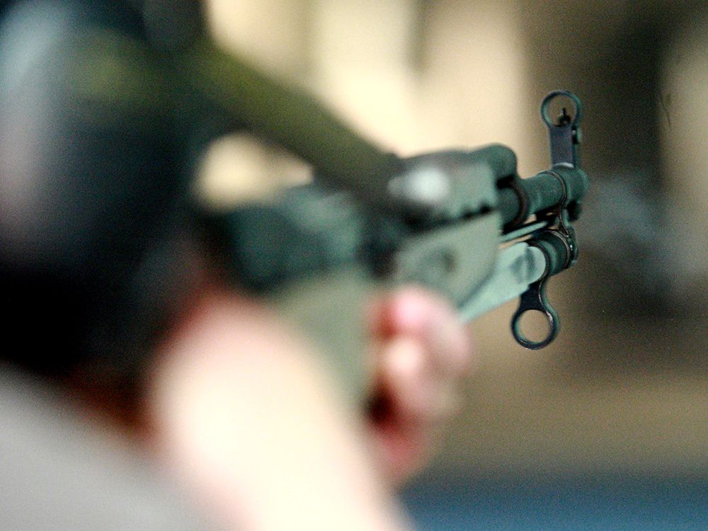  A person fires a SKS rifle at a Calgary shooting range in 2010.