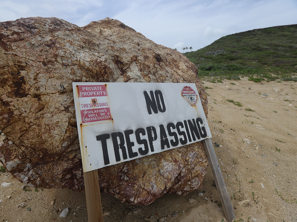  A “No Trespassing” sign is seen on one of the two islands.