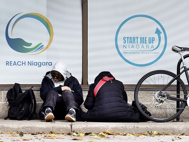 Drug addicts sitting outside a social-service agency in downtown St. Catharines, Ont.