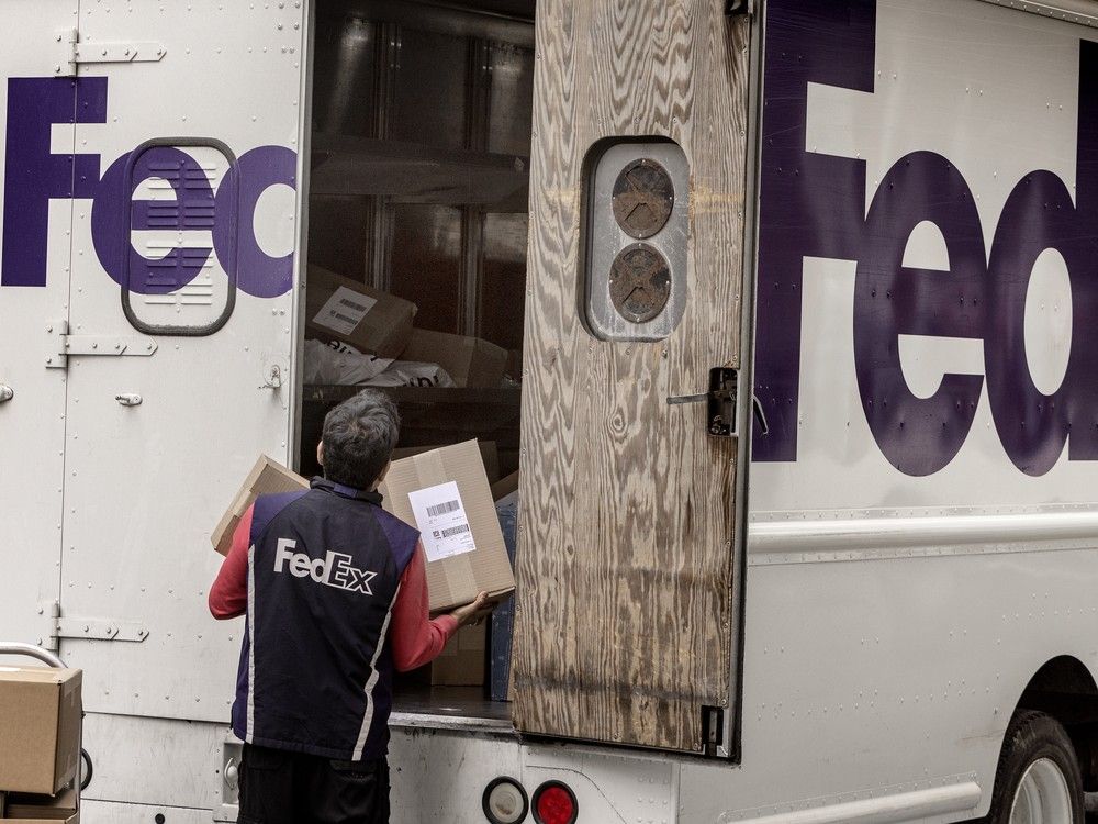  A FedEx employee loads his truck on Toronto’s Bloor Street.
