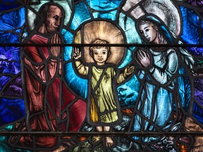 Joseph, Jesus and Mary in stained glass.