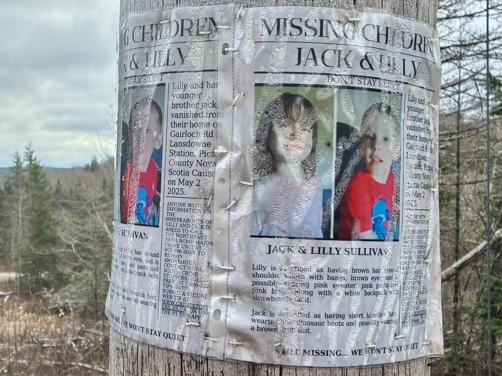  A missing persons poster of Lilly and Jack Sullivan on a telephone pole near the home along Highway 289.