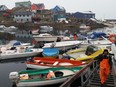A fisherman in Maniitsoq, Greenland, arrives from the salmon catch in September, 2015.