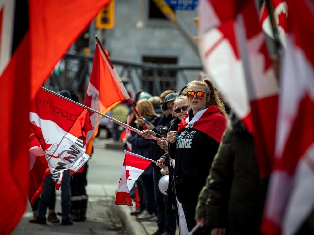 A group of demonstrators were out to support a passing convoy of anti-mandate motorists that rolled through Ottawa’s downtown, Saturday, March 26, 2022.