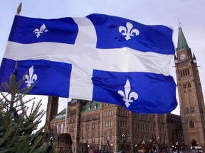 Quebec flag flies over Parliament buildings in Ottawa.