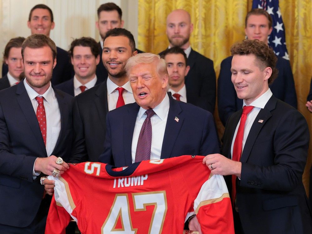  U.S. President Donald Trump is presented with a jersey and hockey stick by Florida Panthers owner Vincent Viola (L), Aleksander Barkov and Matthew Tkachuk of the Florida Panthers during a ceremony to honor the 2025 Stanley Cup Champion Florida Panthers in the East Room of the White House on Jan. 15, 2026 in Washington, DC.