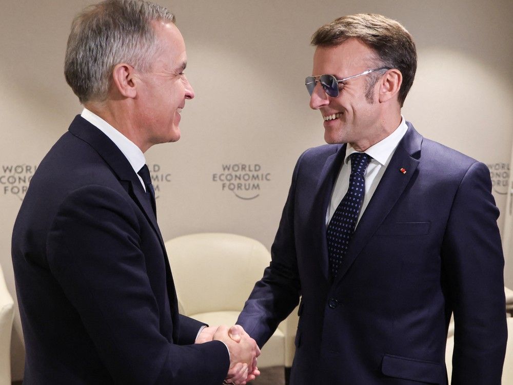 French President Emmanuel Macron, right, greets Canadian Prime Minister Mark Carney prior to a bilateral meeting on the sidelines of the World Economic Forum (WEF) annual meeting in Davos, Switzerland on Tuesday.