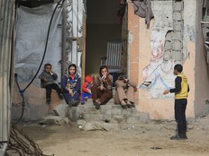 Children in front of damaged house.