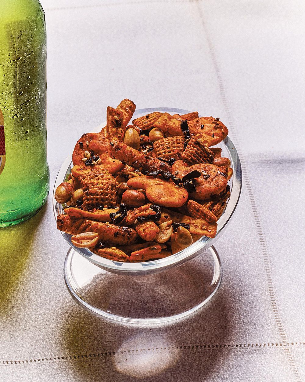  Serving something crunchy, like her chili crisp snack mix, before a hot pot meal whets the appetite and “sets the stage for what’s to come,” says Natasha Pickowicz.