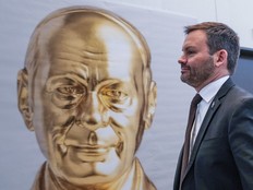 Parti Québécois Leader Paul St-Pierre Plamondon walks by an art installation depicting PQ founder Réne Lévesque, following a press conference at their party convention in St-Hyacinthe on Friday, Jan. 23, 2026.