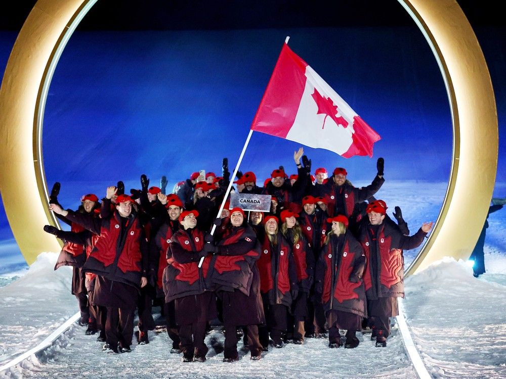 LIVIGNO, Italy: Marielle Thompson and Mikael Kingsbury, flagbearers of Team Canada, enter the stadium with the team during the Opening Ceremonies of the Milano Cortina 2026 Winter Olympics at Livigno Snow Park. LIVIGNO, Italy: Marielle Thompson and Mikael Kingsbury, flagbearers of Team Canada, enter the stadium with the team during the Opening Ceremonies of the Milano Cortina 2026 Winter Olympics at Livigno Snow Park.