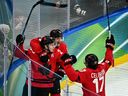 Canada's Nathan Mackinnon (left) celebrates after scoring the game-winning goal against Finland during the men's play-off semifinal at the Milano Cortina 2026 Winter Olympic Games.