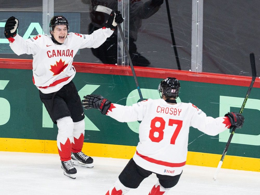 Macklin Celebrini celebrates with Sidney Crosby