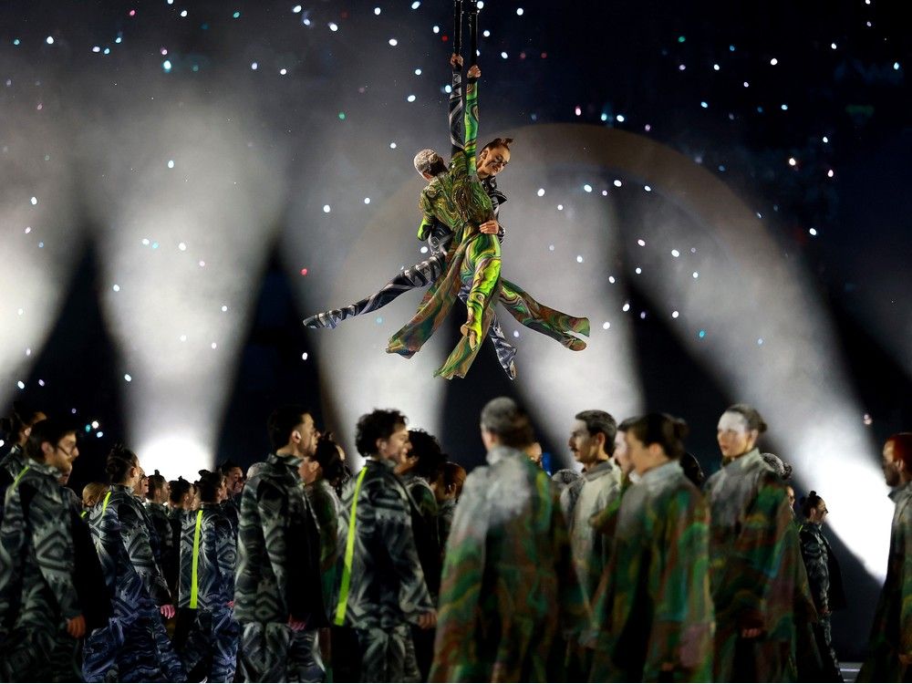 Two aerial actors perform next to the rings representing the city and mountain during the opening ceremony of the Milano Cortina 2026 Winter Olympics at San Siro Stadium on Feb. 06, 2026 in Milan, Italy. Two aerial actors perform next to the rings representing the city and mountain during the opening ceremony of the Milano Cortina 2026 Winter Olympics at San Siro Stadium on Feb. 06, 2026 in Milan, Italy.