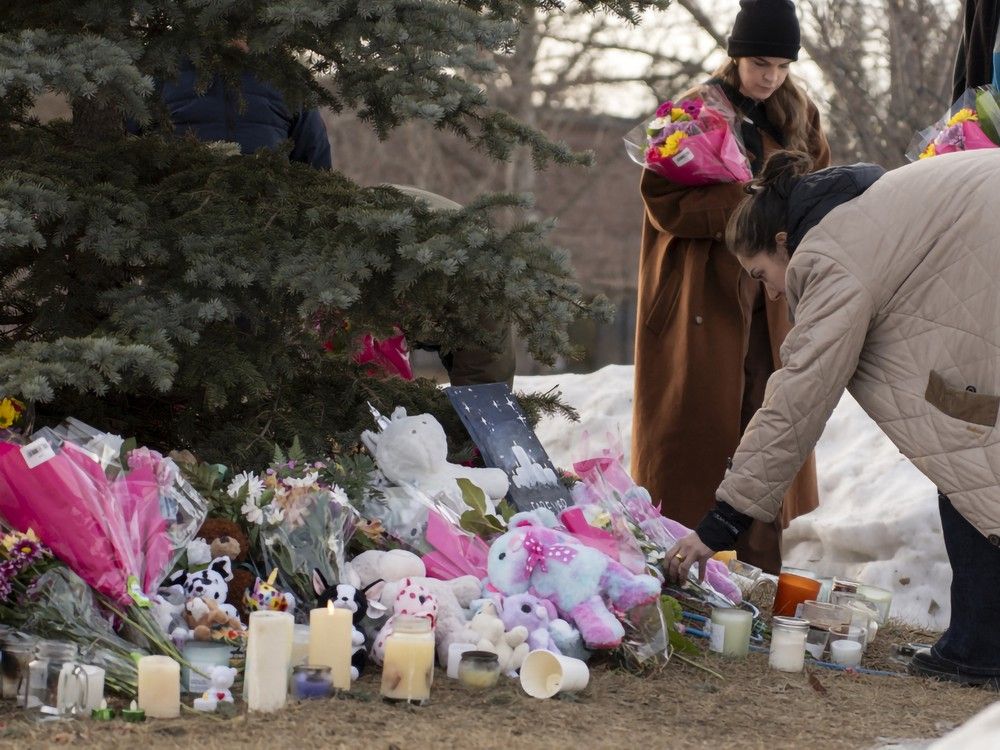  People bring flowers and pay their respects at a community vigil in Tumbler Ridge two days after the rural community experienced one of Canada’s deadliest shootings on February 12, 2026.