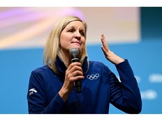 Kirsty Coventry speaking into a microphone